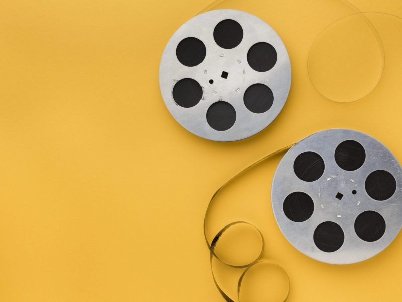 film-rolls-yellow-background-with-copy-space
